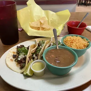 Beef fajita tacos plate with charro beans.