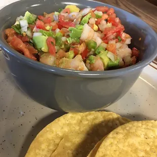 a bowl of salsa and two tortillas