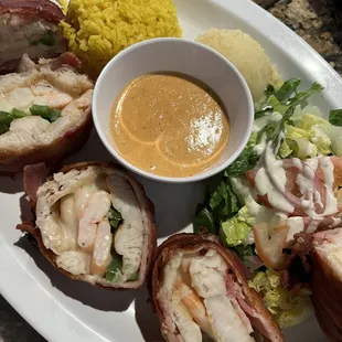 a plate of food with a bowl of sauce