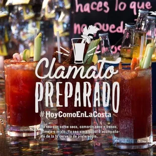 two glasses of bloody cocktails on a bar