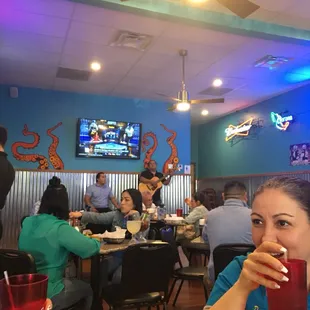 a woman sitting at a table in a restaurant