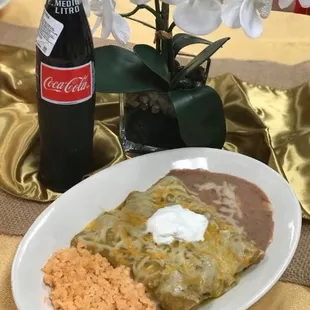a plate of mexican food and a bottle of coke