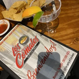 a table with a menu and drinks