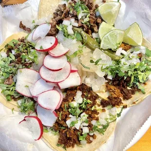 two tacos on a paper plate