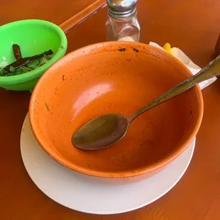 a bowl and spoon on a table