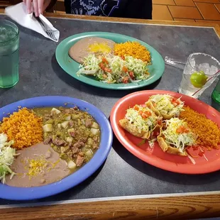 three plates of mexican food on a table