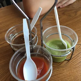 three cups of sauce and a spoon
