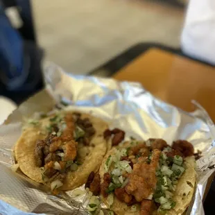two tacos on tin foil