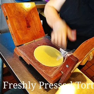 a person cutting a tortilla