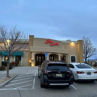 two cars parked in front of a restaurant