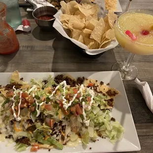 Nachos Supreme - ground beef, lettuce, tomatoes, red onions, melted cheddar cheese &amp; Queso.  Small frozen House Margarita - very good.