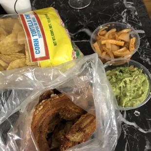 Fried pork skin with meat, Guacamole, and pickled pork skin