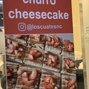 a sign for churro cheesecake