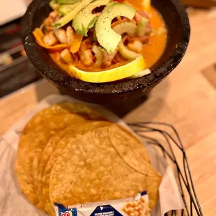 a bowl of salsa and tortillas