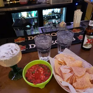 Margarita, chips and salsa and beer, sitting at the small bar