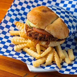 a pulled pork sandwich and french fries