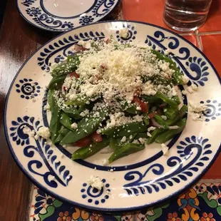 a plate of green beans and cheese