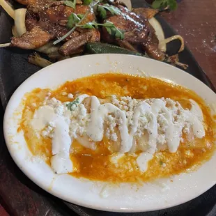 This is a fabulous combination plate with a cheese enchilada and two small quail served on a bed of grilled onions.