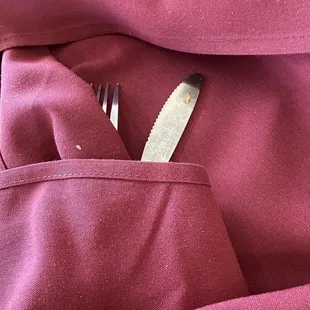 Someone food on clean silverware second napkin has left over lint!