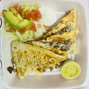 a plate of quesadillas and a salad