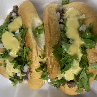 two sub sandwiches with cheese and lettuce