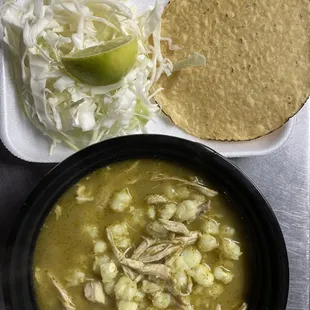 a bowl of soup and a tortilla