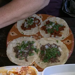 a plate of tacos and a plate of guacamole