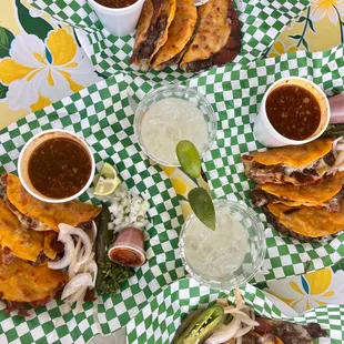 ig: @whatsviveating  |  plate of birria tacos, consommé, and draft mezcal margaritas