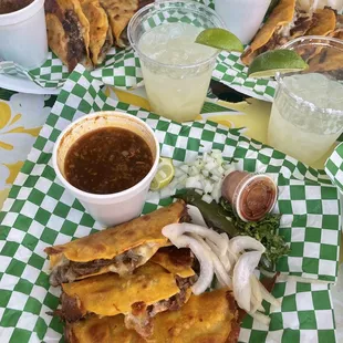 ig: @whatsviveating  |  plate of birria tacos, consommé, and draft mezcal margaritas
