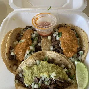 Steak tacos with a side of homemade hot sauce