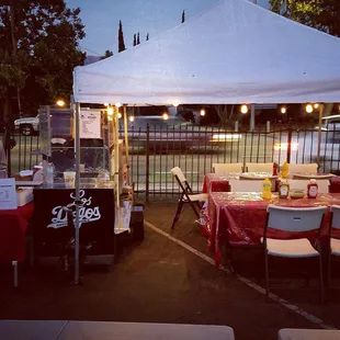 a tent set up with tables and chairs