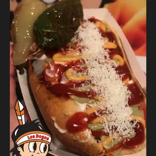 a hot dog with cheese and pickles