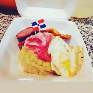 Mangú con Los Tres Golpes: Butter mashed plantains with pickled onions, fried salami, fried cheese, sunny side up egg