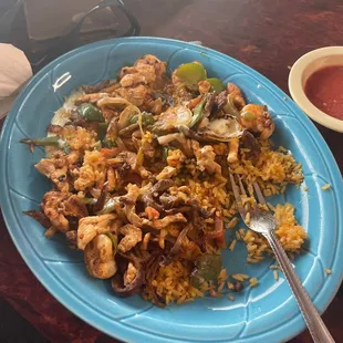Shrimp, Steak, Grilled Chicken, Mexican Rice, Onions, Tomatoes with a side of three fresh tortillas. Favorite thing on the menu!