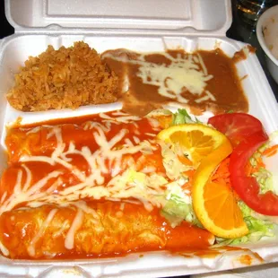 pork enchiladas with beans, rice, and salad.