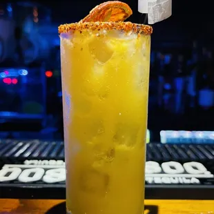 a cocktail with orange garnish