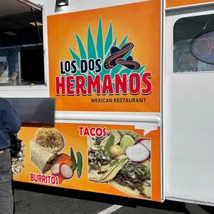 a man standing in front of a food truck