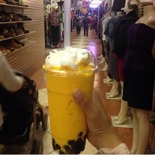 a hand holding a cup of ice cream