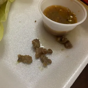 a bowl of sauce and a burrito