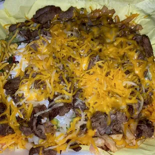 Super Fries (carne asada fries) from Los Fredos on Jackson/Magnolia. Hits the spot at 1am with an ice cold Horchata to wash it down....