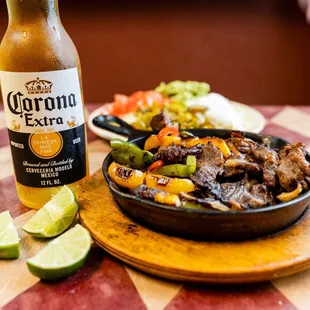 a plate of food and a bottle of corona extra