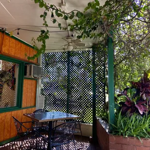 a patio with a table and chairs