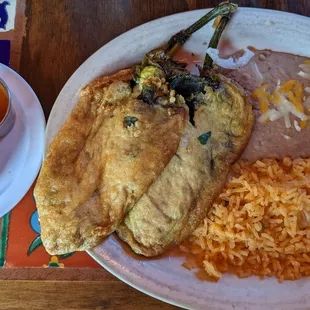 Chile relleno with enchilada sauce and cheese sauce