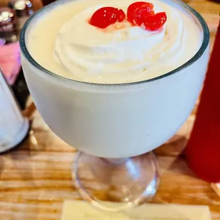 a drink with whipped cream and cherries