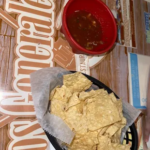 a bowl of chips and a bowl of salsa
