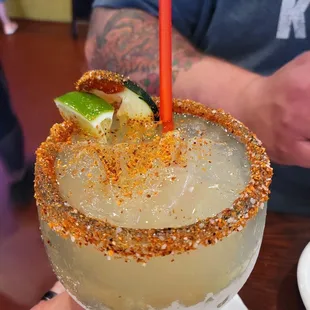 a person holding a margarita