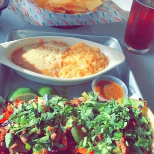 Street Tacos Al Carbon Steak, Chorizo, Pineapple w/ Peppers and Cilantro  Rice and Beans  Modelo Negra