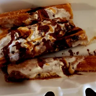 a banana split with whipped cream and chocolate sauce