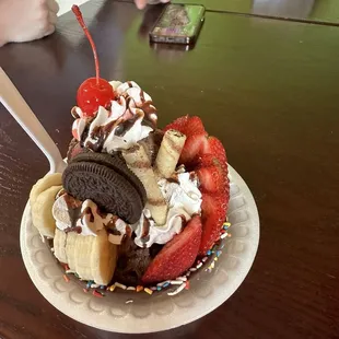 Waffle bowl ice cream with fresh strawberries, banana slices and cookies. Beautifully done.