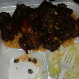 this is fried chicken, rice and peas, tostones and a small salad